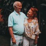 An elderly couple smiling at each other