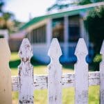 a picket fence between two gardens