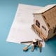 granny annexe insurance blog title image of a wooden house, keys and paperwork
