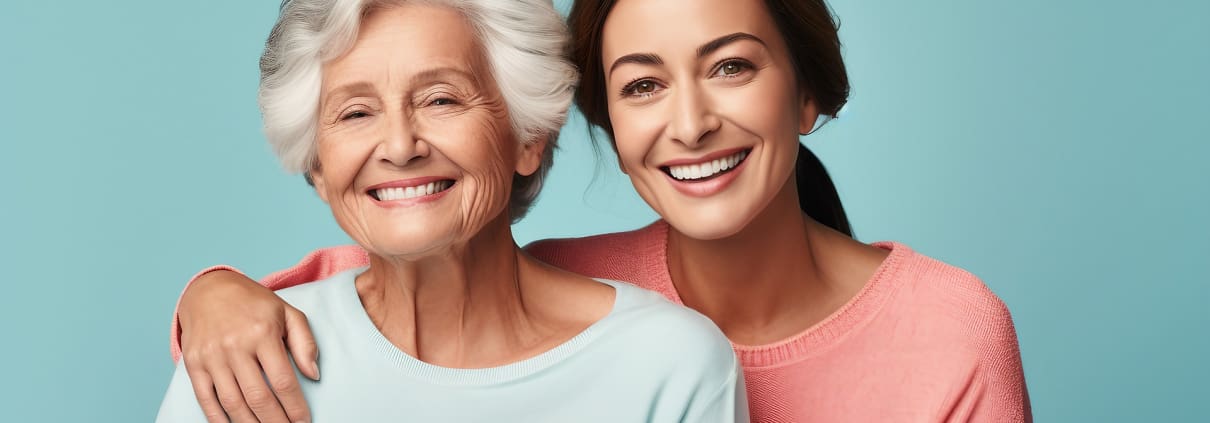two women smiling, one is older and one is younger