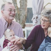 image shows grandparents with their two grandchildren