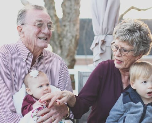 image shows grandparents with their two grandchildren